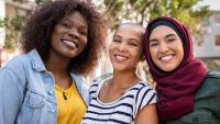 Group of three happy multiethnic friends